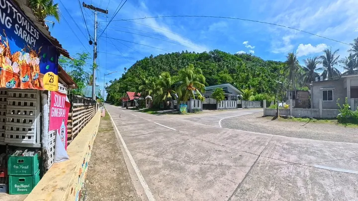 Sunny road junction and community profile view in Camantaya, San Agustin, Romblon